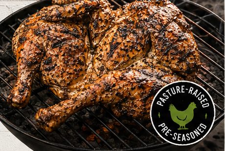A FlatBird cooking over charcoal